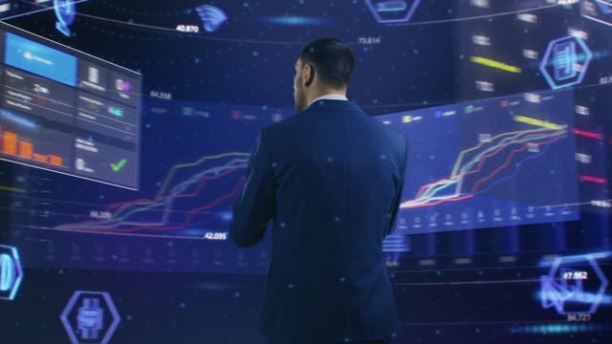 Virtual Reality Concept: Businessman Uses Smartphone in 3D World Surrounded by e-Business, e-Commerce, Stock Market, Infographics, Finance, Analysis, Charts, Graphs Icons. 360 Degree Tracking Arc Shot